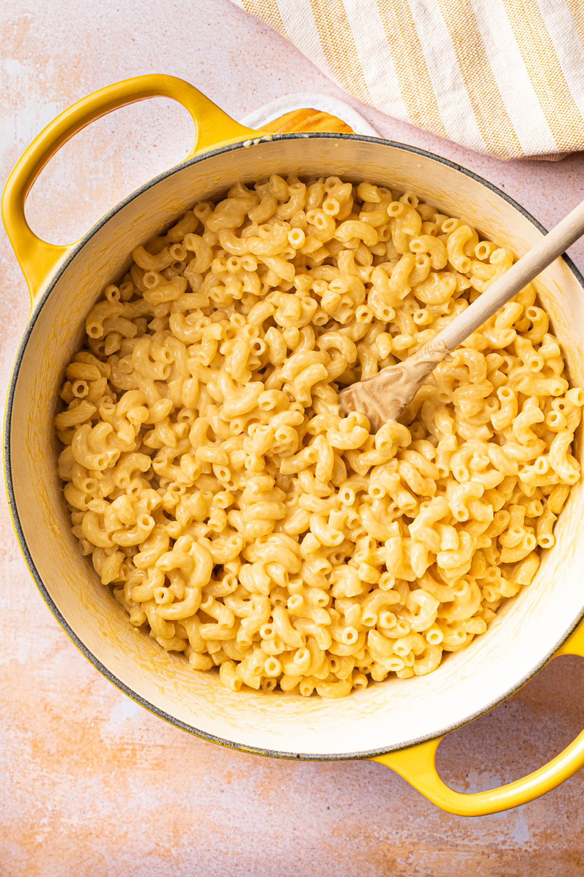Creamy mac and cheese in a yellow dutch oven. 
