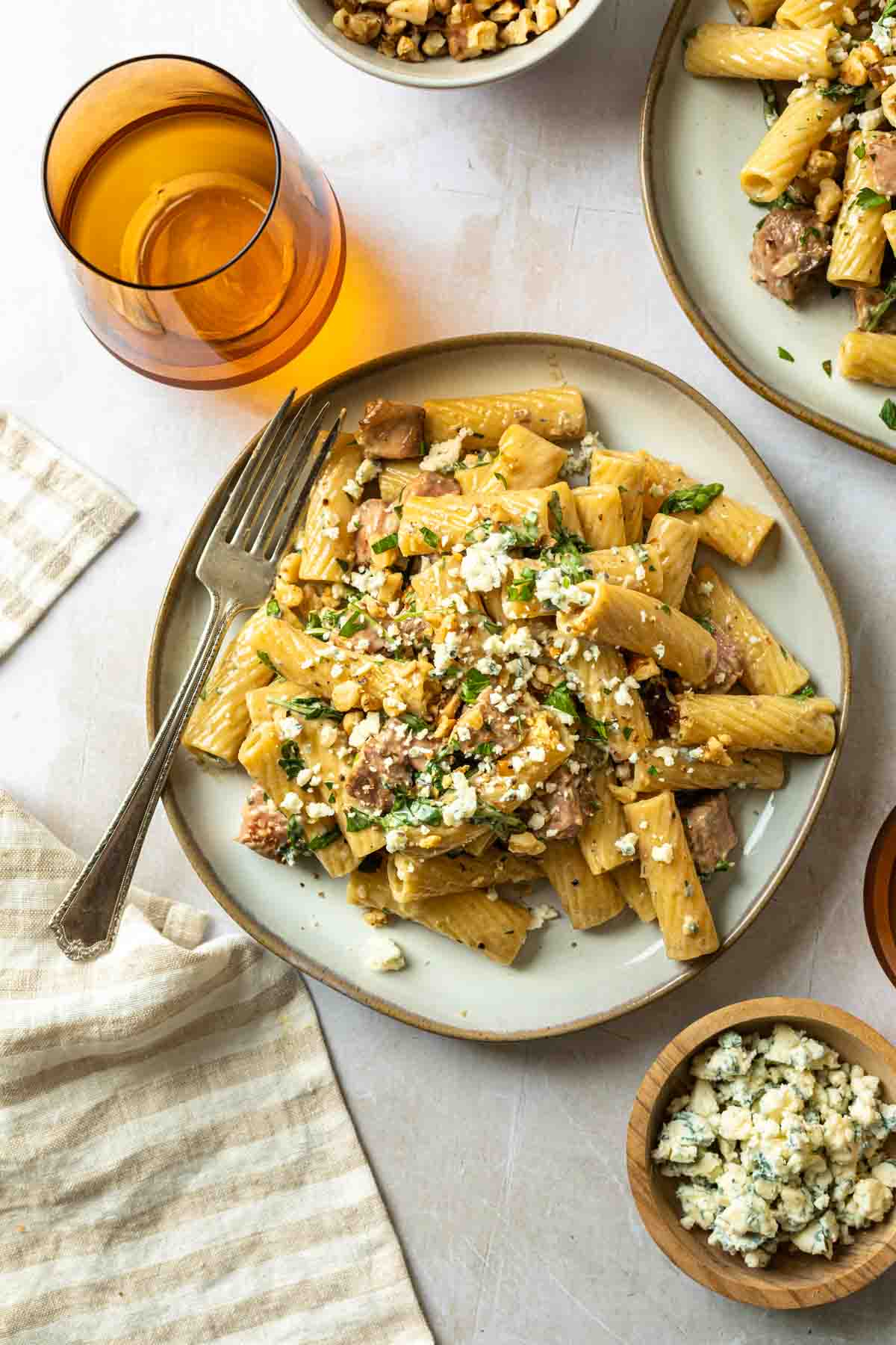 Rigatoni with steak and walnuts with a gorgonzola sauce on a plate. 