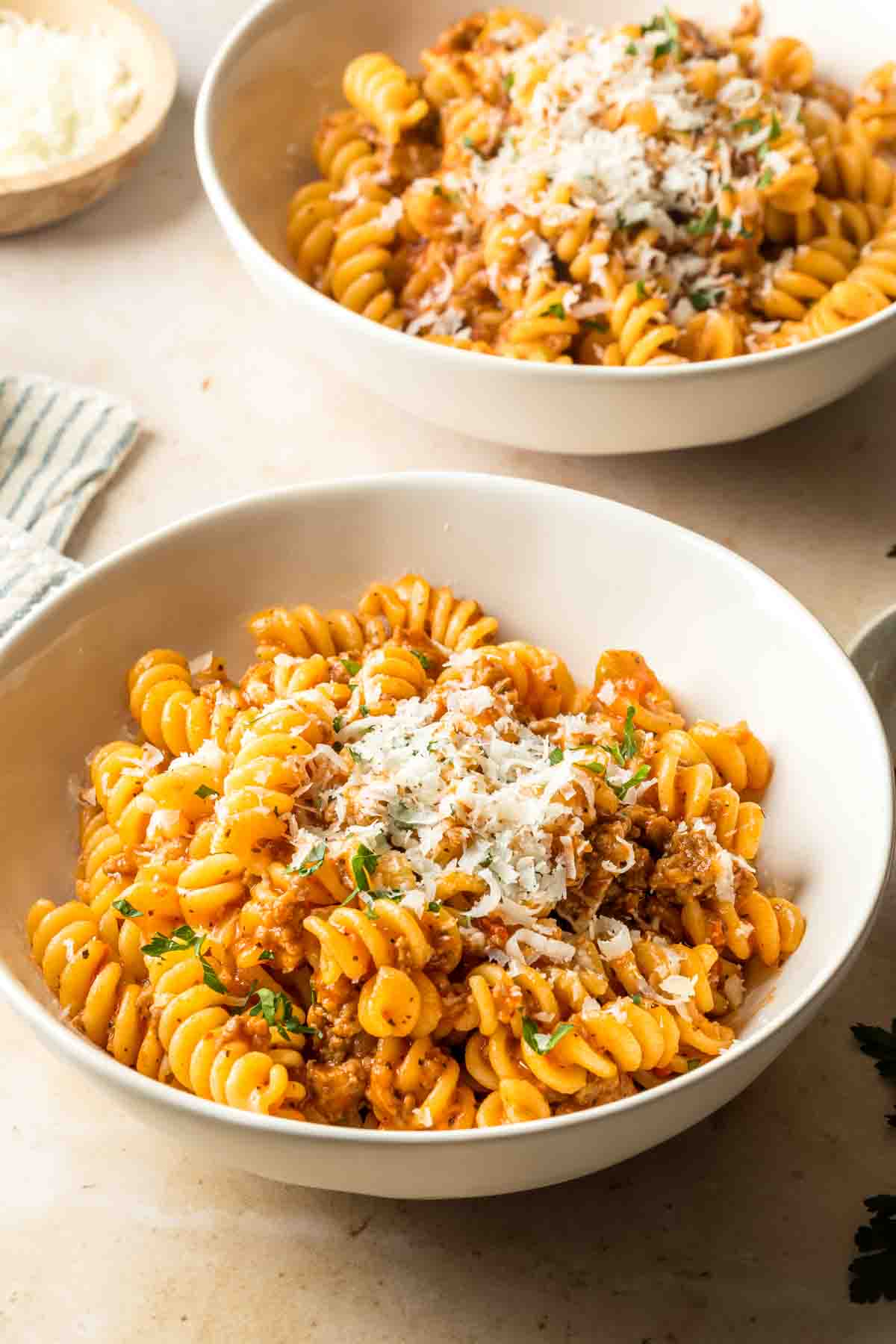Two bowls of spicy sausage pasta. 